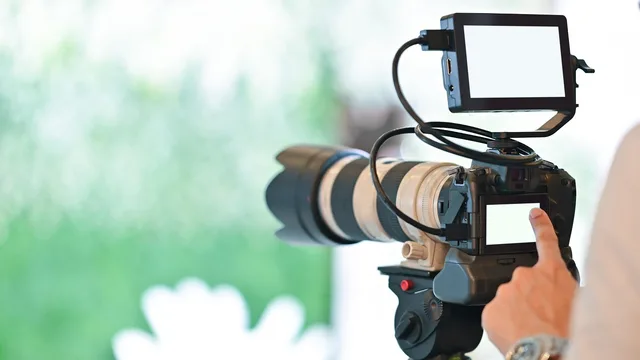 camera, camera man, blank screen, blur, closeup, focus, light, media. Checking the advertising claims in a creator media kit before it goes out